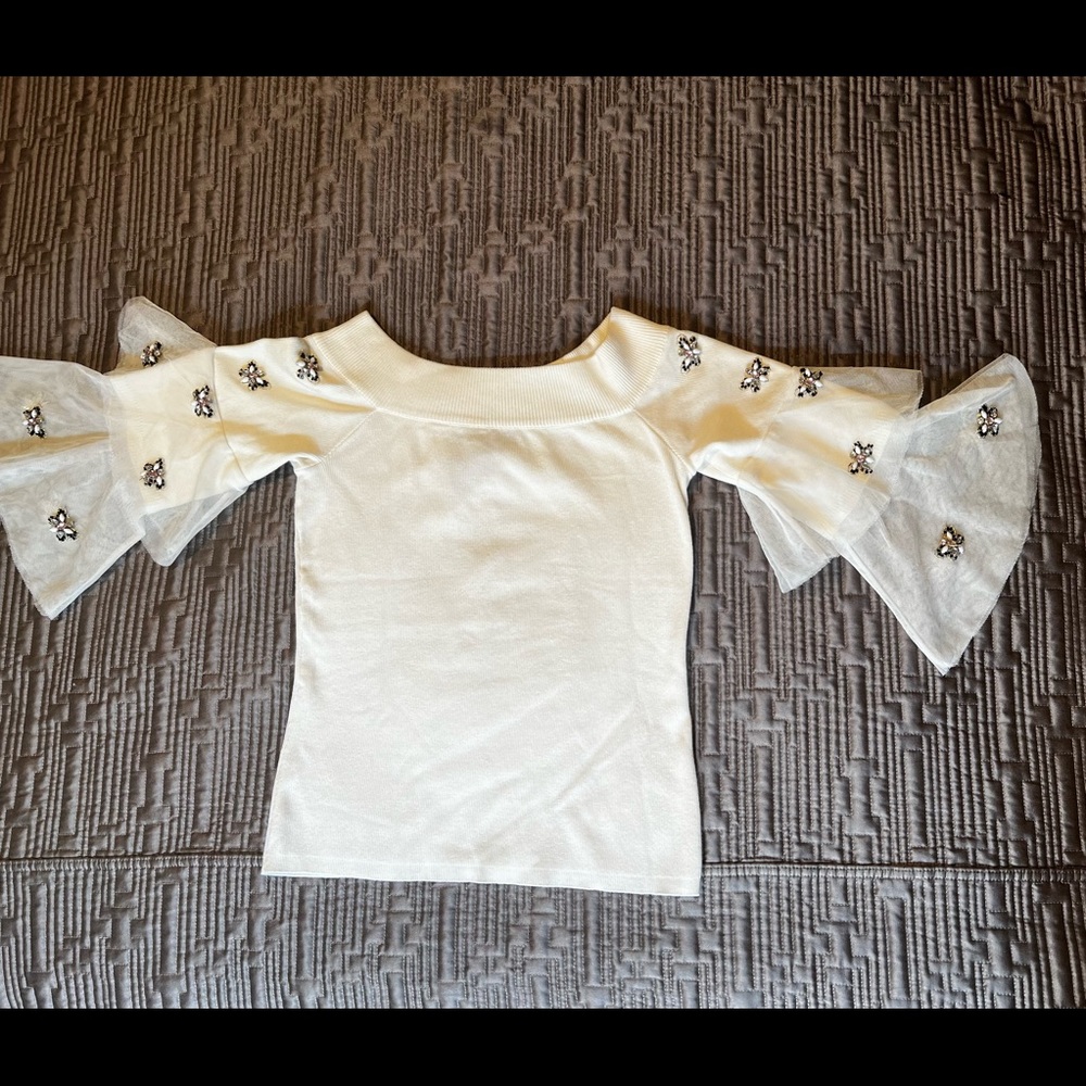 Super cute cropped off the shoulder sweater with embellishments